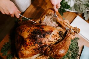 Someone Cutting into a turkey