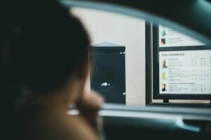 Someone ordering food through a drive thru
