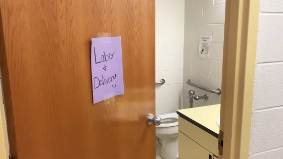 A school bathroom with a sign that says Labor and Delivery