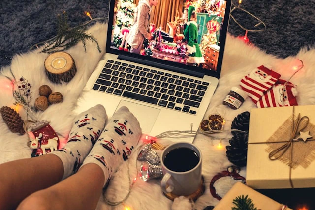 Someone looking cozy watching a Christmas movie