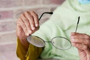 Someone holding up a pair of glasses